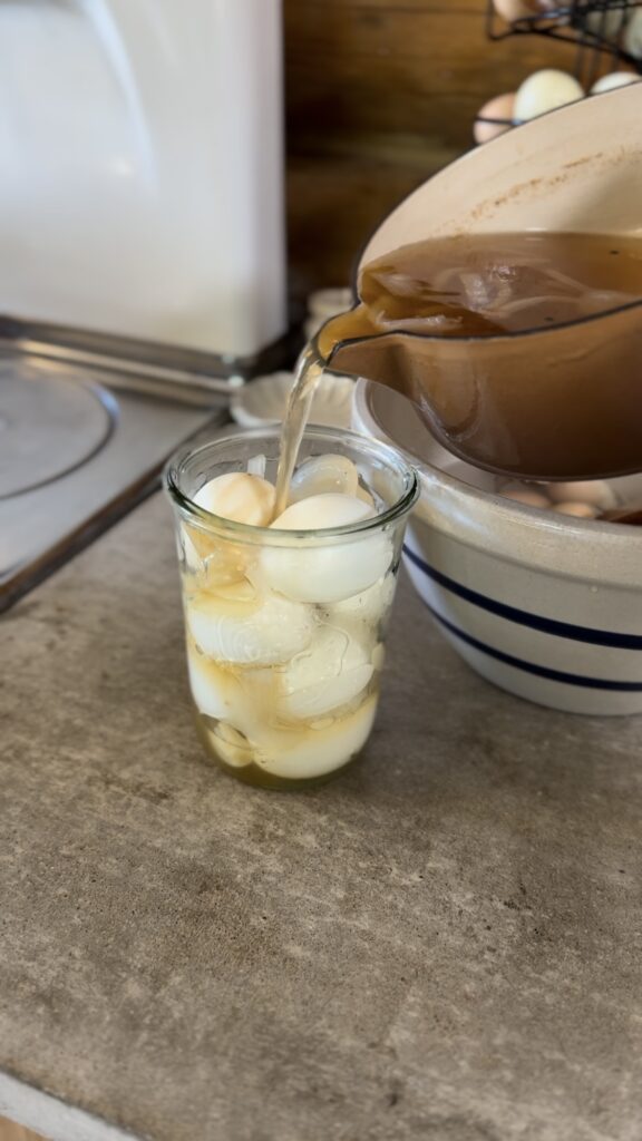 brine pouring over boiled eggs